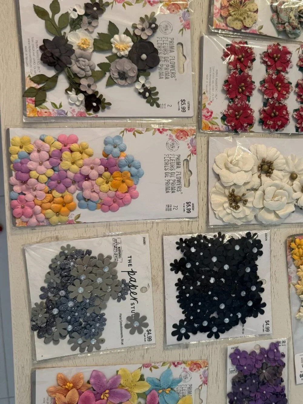 10 packages of fabric floral embellishments, NWT in beautiful colors